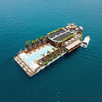 Aerial view of luxury floating platform resort on the sea by eDrive Water Sports Dubai
