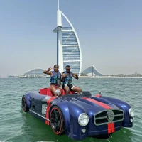 Couple enjoying jet car ride near Burj Al Arab in Dubai