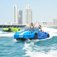 Couple enjoying blue jet car ride in Dubai Marina sea